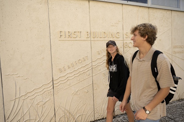 Students in Front of Map Wall