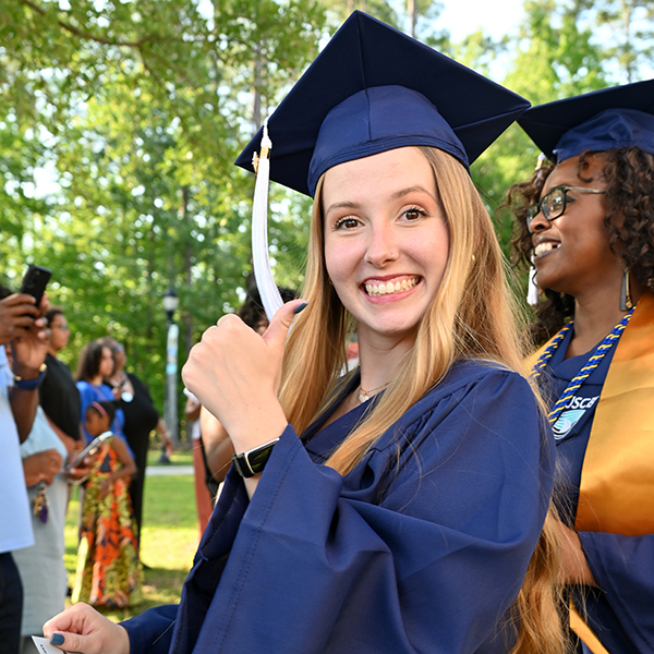 Graduate giving the thumbs up sign Graduate giving the thumbs up sign