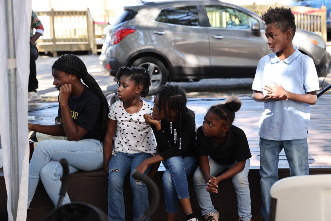 Children intently watching BJ Dennis discuss rice at the 2024 Gullah Food Festival 