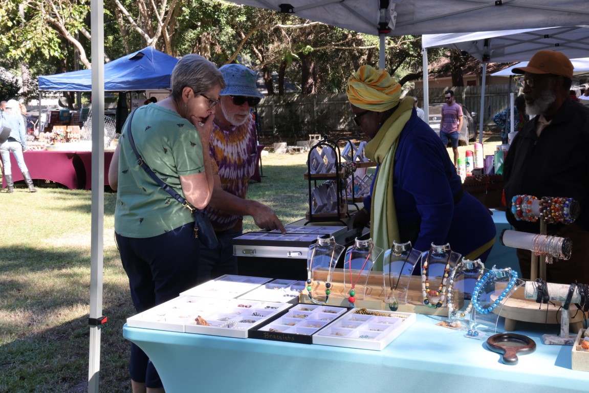 Guests looking over Gullah art at the 2024 Gullah Food Festival 