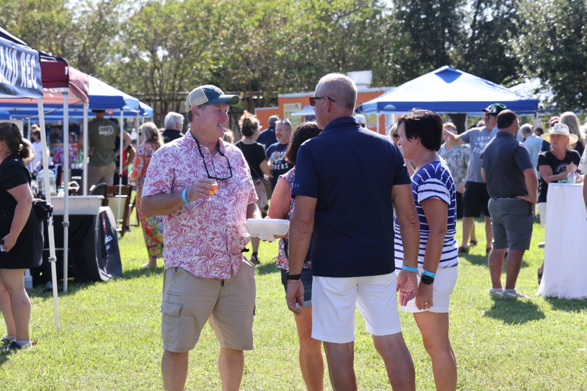 A small group of people talking to each other at the 2024 Rhythm and Brews Festival