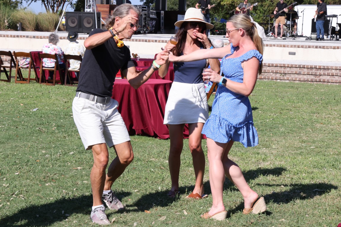 Three people dancing  at the 2024 Rhythm and Brews Festival