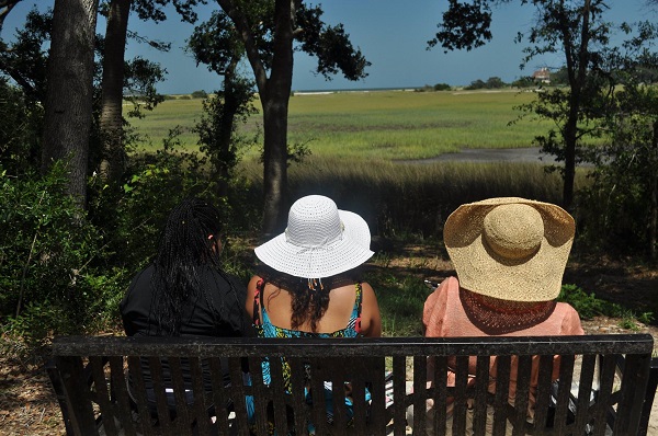 People on Bench Overlooking Nature