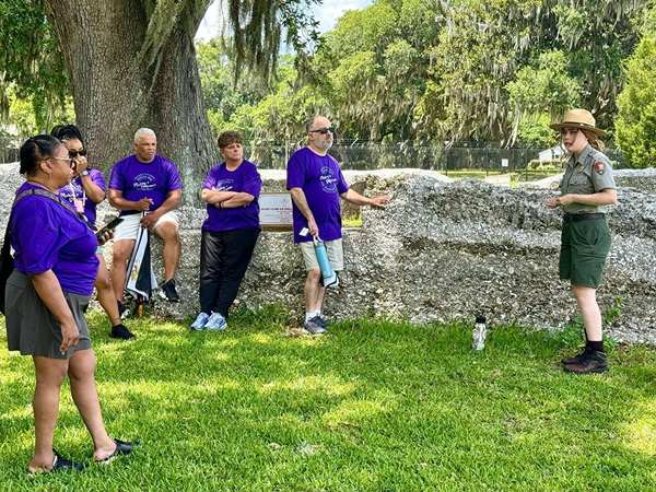 Group listening to teacher on site