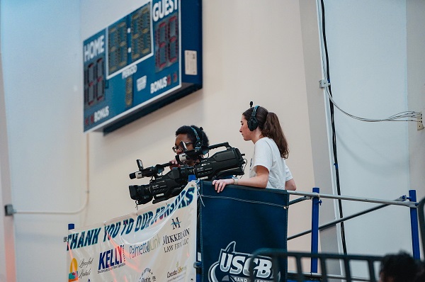 Shot of several students one filming