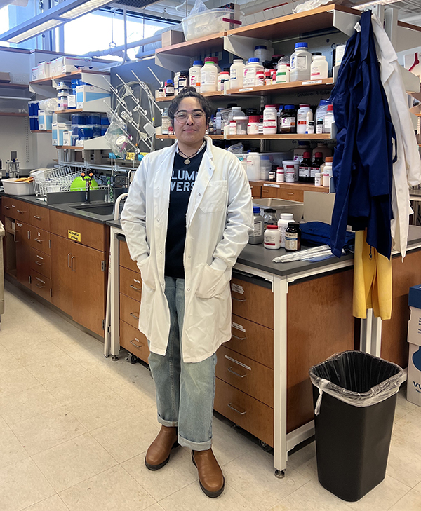 Denia Lopez in lab coat in lab